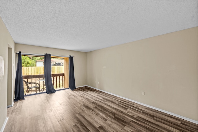 empty room featuring hardwood / wood-style floors and a textured ceiling