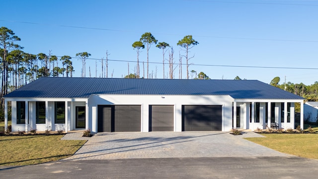 view of front of house with a garage and a front yard