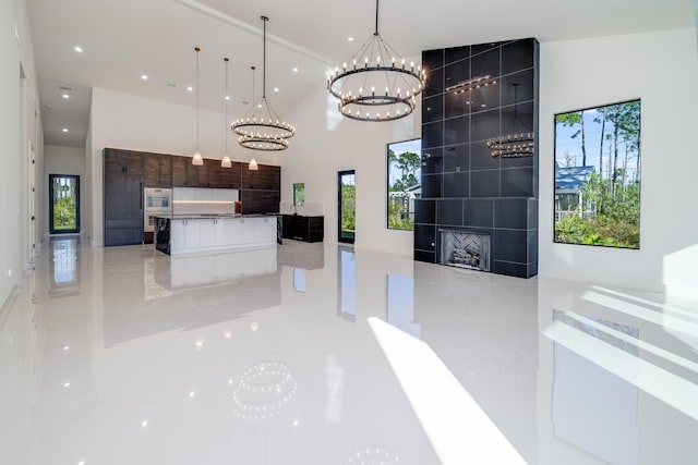 kitchen featuring a chandelier, light tile patterned floors, decorative light fixtures, and a healthy amount of sunlight