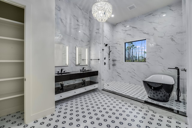 bathroom with sink, independent shower and bath, and an inviting chandelier