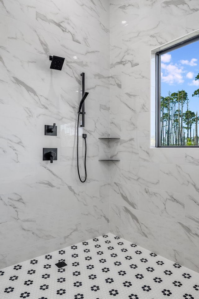 bathroom with tiled shower