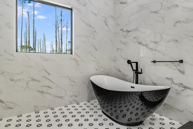 bathroom featuring a tub to relax in and tile walls