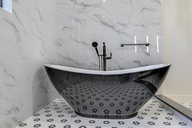 bathroom with a bath and tile walls