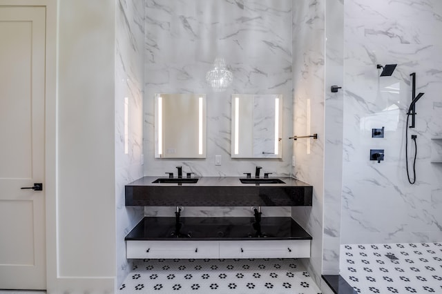 bathroom featuring vanity, a shower, and an inviting chandelier