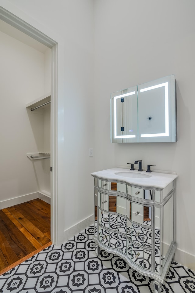 bathroom with hardwood / wood-style floors and vanity