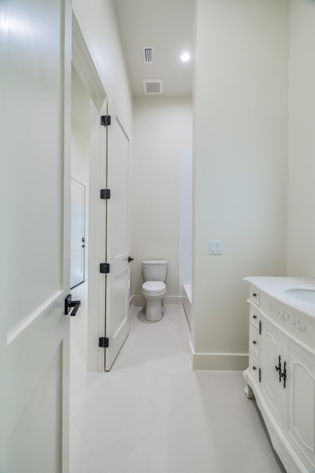 bathroom with a shower, vanity, and toilet