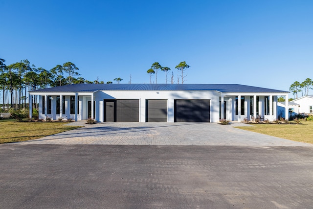 view of front facade with a front yard and a garage