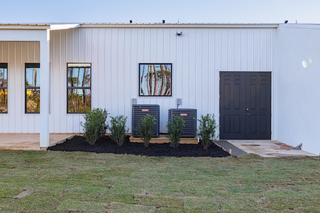 exterior space featuring a yard and cooling unit