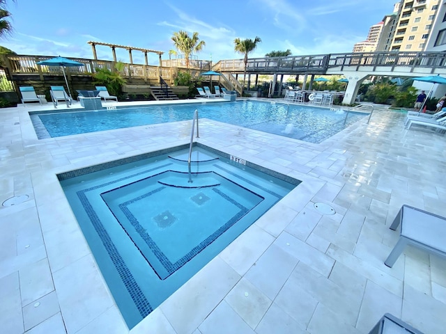 view of pool featuring a community hot tub