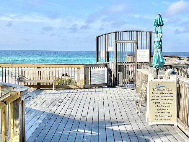 deck featuring a water view and a view of the beach