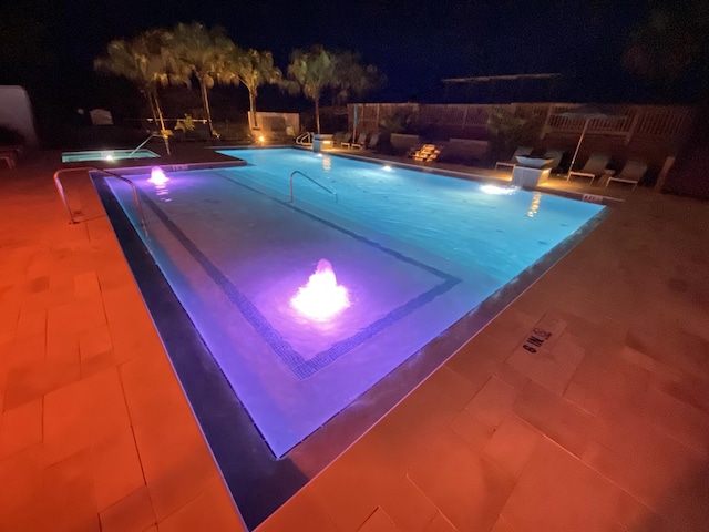 view of pool at night