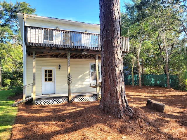 rear view of property featuring a deck