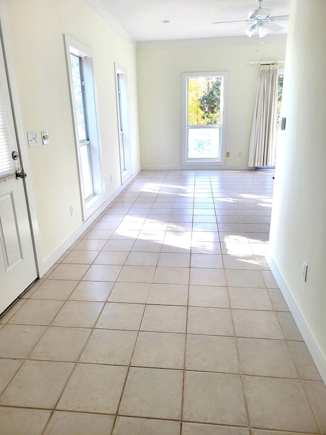 empty room featuring light tile patterned floors and ceiling fan