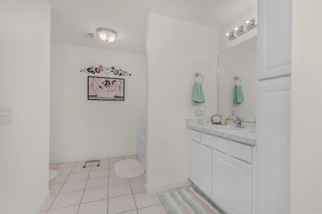 bathroom featuring a tub, tile patterned flooring, and vanity