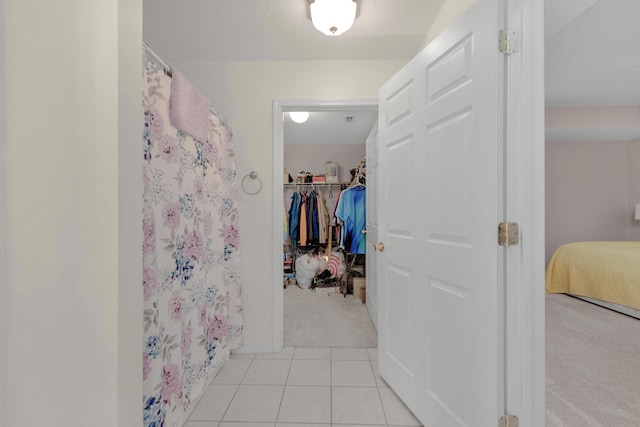 bathroom with a shower with curtain and tile patterned flooring