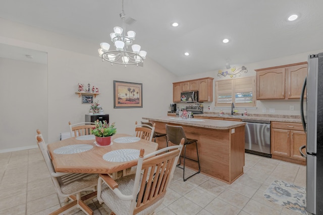 tiled dining space with a chandelier, sink, and vaulted ceiling