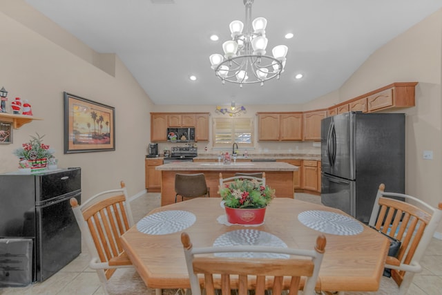 tiled dining area with sink, vaulted ceiling, and a notable chandelier