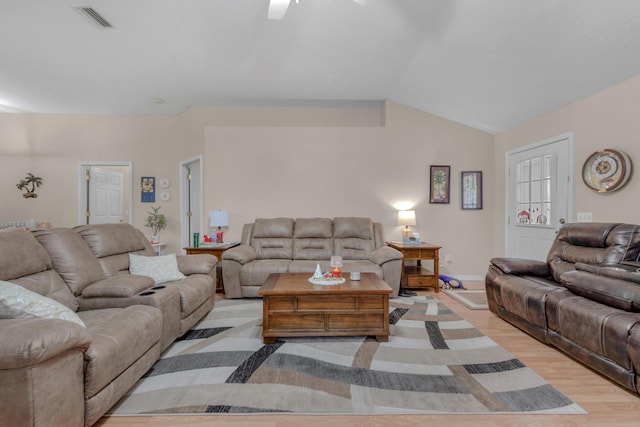 living room featuring light hardwood / wood-style floors and lofted ceiling