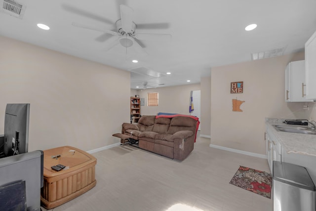 living room with ceiling fan and sink