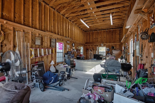 garage with a workshop area and wood walls