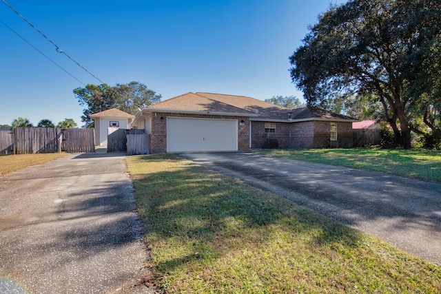 ranch-style home with a garage and a front lawn