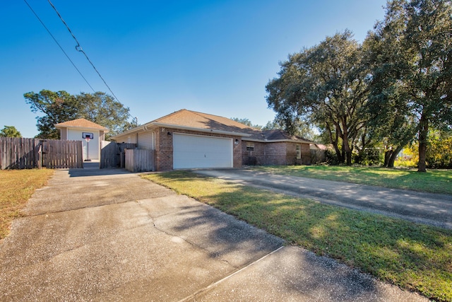 single story home with a front yard and a garage