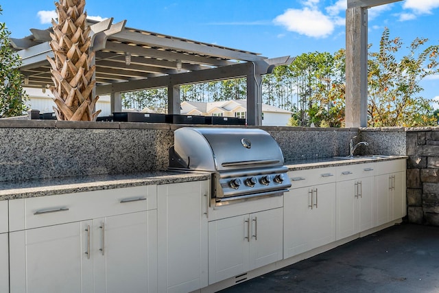 view of patio / terrace featuring area for grilling, a grill, and sink