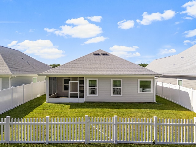 back of house with a lawn and a sunroom