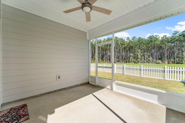 unfurnished sunroom with ceiling fan