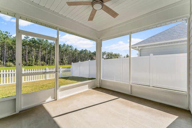 unfurnished sunroom with ceiling fan