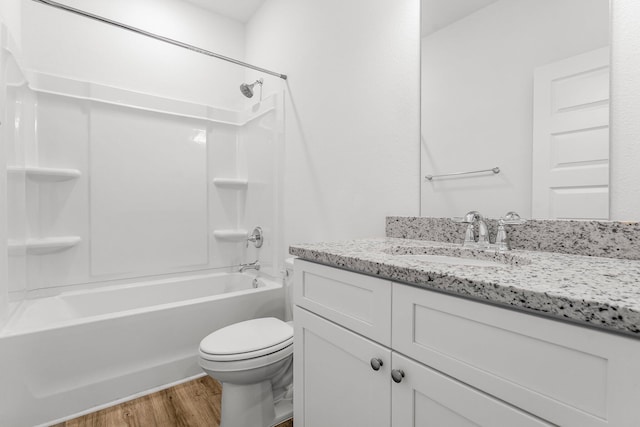 full bathroom featuring vanity, hardwood / wood-style flooring, toilet, and tub / shower combination