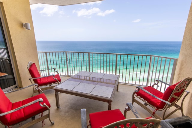 balcony featuring a water view and a view of the beach