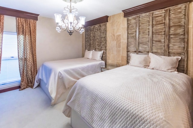 carpeted bedroom featuring a chandelier