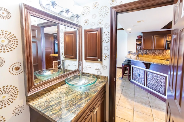 bathroom with vanity, tile patterned floors, and backsplash