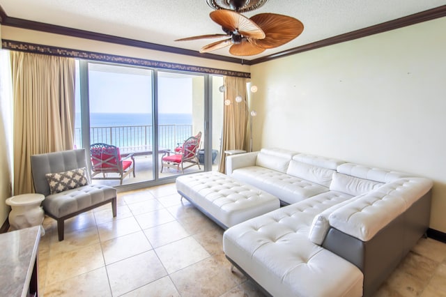 tiled living room featuring a water view, ornamental molding, and a textured ceiling