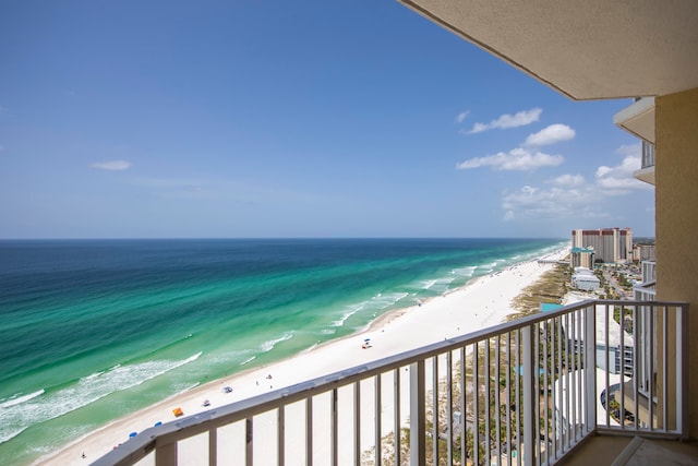 balcony with a water view and a beach view