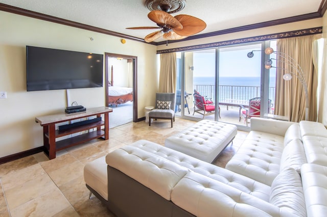 living room with ceiling fan, ornamental molding, and a textured ceiling