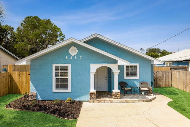 bungalow-style home with a front lawn