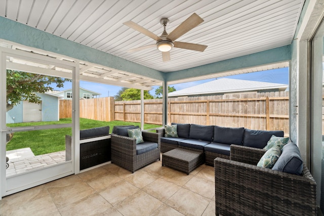 sunroom with ceiling fan and wooden ceiling