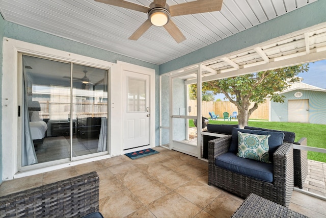 sunroom featuring ceiling fan