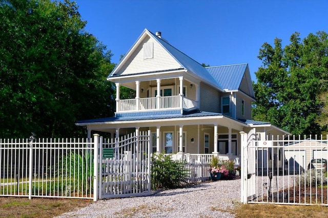 14138 State Highway 20, Niceville, FL 32578 - view of front facade with a porch, a gate, a fenced front yard, and a metal roof