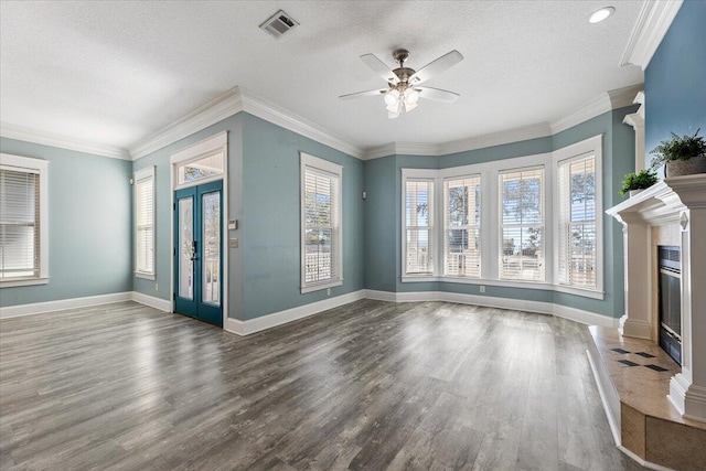 14138 State Highway 20, Niceville, FL 32578 - unfurnished living room with a fireplace with flush hearth, ceiling fan, wood finished floors, a textured ceiling, and ornamental molding