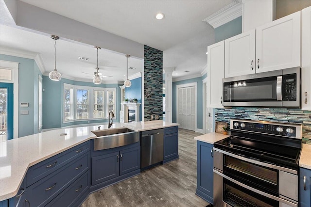 14138 State Highway 20, Niceville, FL 32578 - kitchen featuring stainless steel appliances, crown molding, blue cabinetry, dark wood-style floors, and recessed lighting