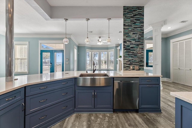 kitchen featuring sink, decorative light fixtures, stainless steel dishwasher, and ornate columns