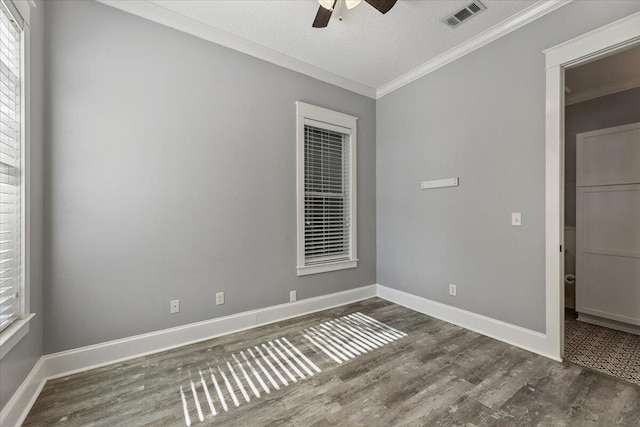 unfurnished room featuring a textured ceiling, ceiling fan, dark hardwood / wood-style floors, and ornamental molding