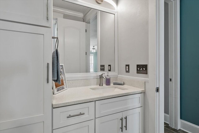 bathroom with vanity, hardwood / wood-style flooring, and crown molding