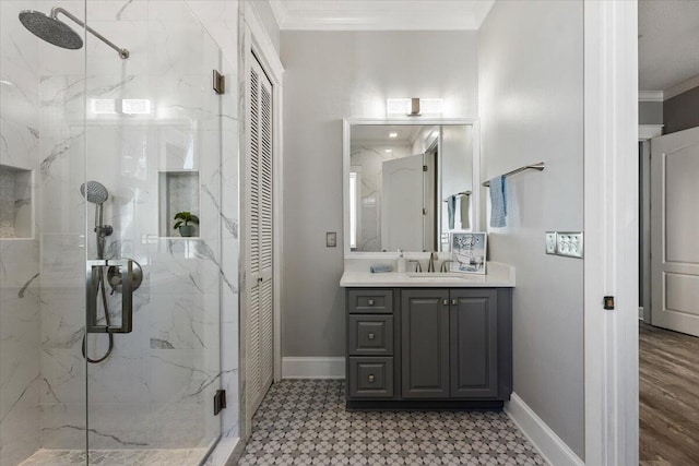 bathroom featuring vanity, an enclosed shower, and ornamental molding