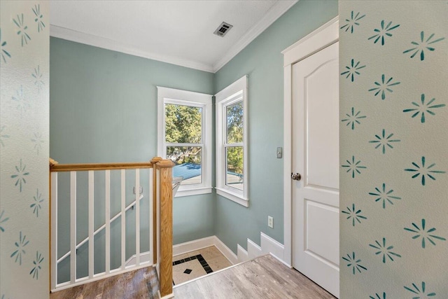 entrance foyer featuring crown molding and wood-type flooring