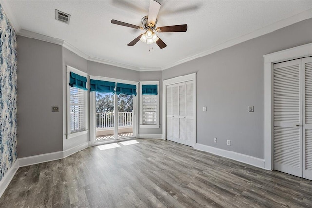 unfurnished bedroom featuring access to outside, ceiling fan, crown molding, and hardwood / wood-style flooring