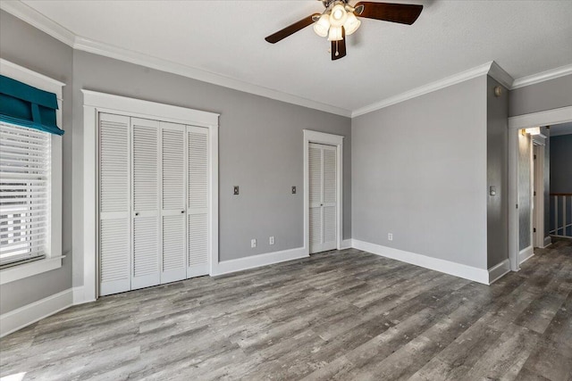 unfurnished bedroom featuring wood-type flooring, a textured ceiling, ceiling fan, and ornamental molding